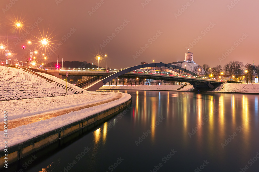 Night Gediminas Tower and King Mindaugas Bridge across Neris River in the city Vilnius, Lithuania, Baltic states.