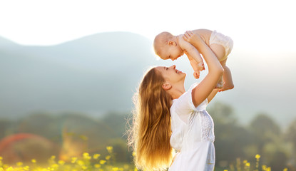 Happy family mother and baby son in  nature in summer