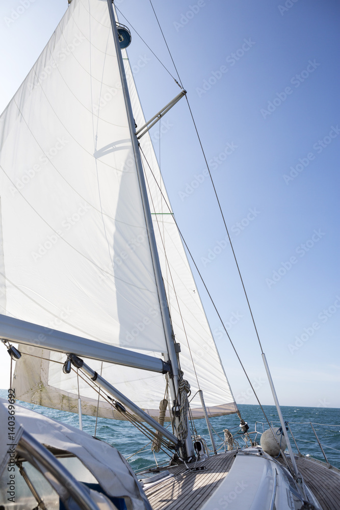 Yacht Sailing On Sea Against Blue Sky