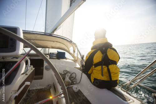 Relaxed Mature Man Sailing On Yacht
