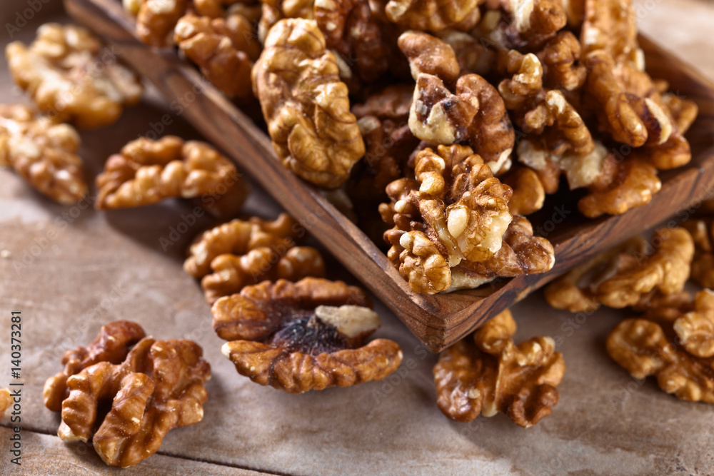 Walnuts in old wooden dish Walnuts in old wooden dish
