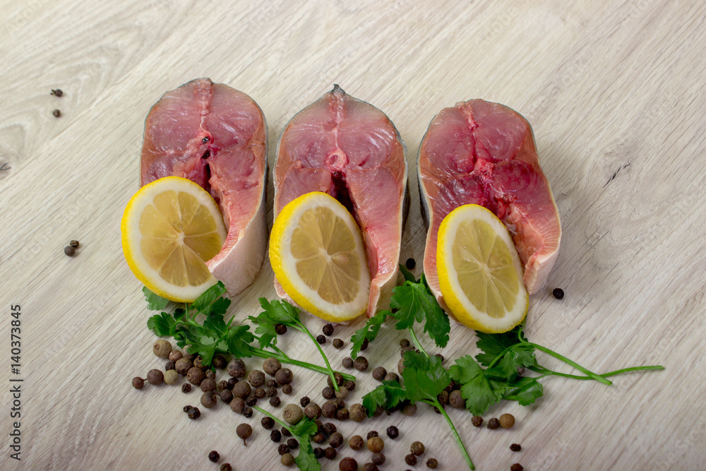 Tuna fillet with lemon, pepper and herbs. Fresh fish.