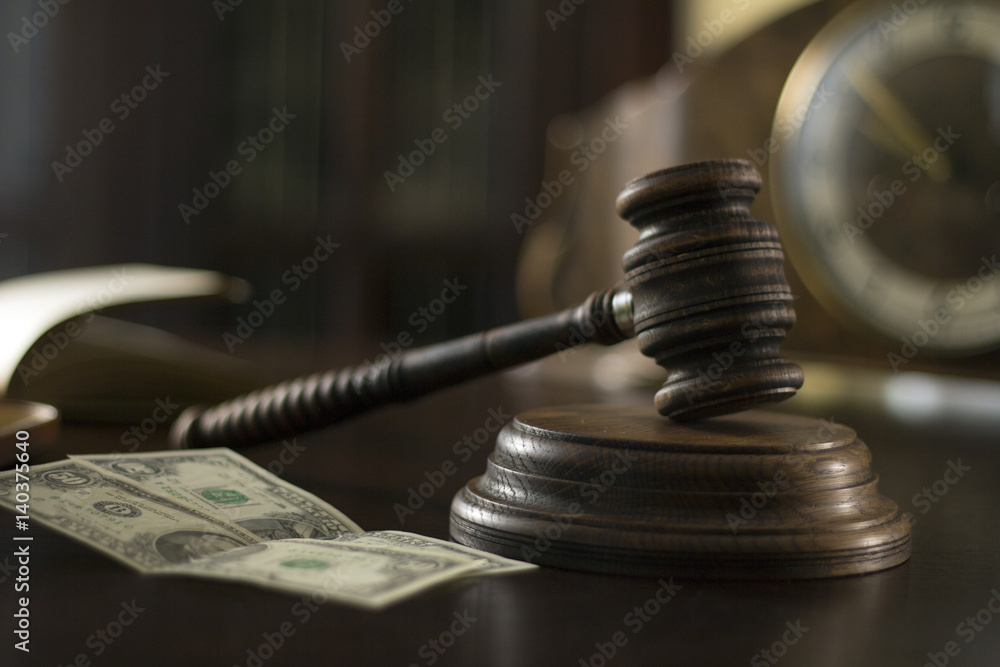 Law theme, mallet of the judge, court gavel wooden rustic desk, handcuffs, candle and books Law theme, mallet of the judge, court gavel wooden rustic desk, handcuffs, candle and books