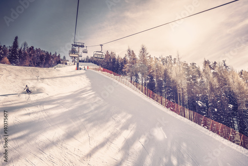 Sunny day on steep ski slope, winter landscape. Vintage filter