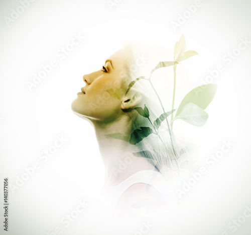 Double exposure of woman and green leaves