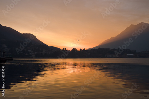 Sunset over the lake with mountains in the background