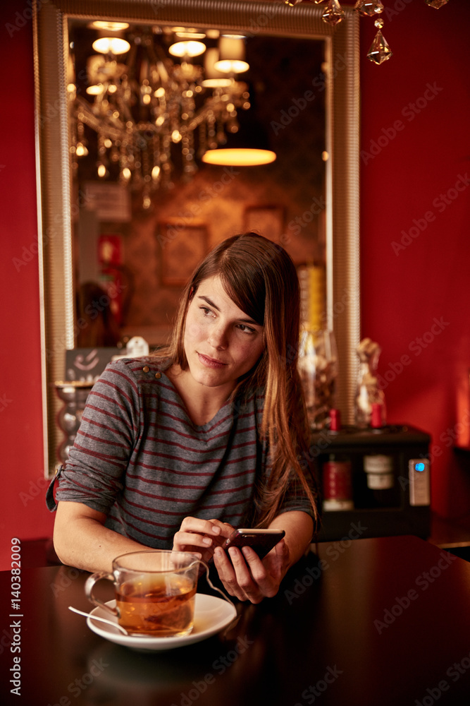 Pretty young lady texting at table Pretty young lady texting at table