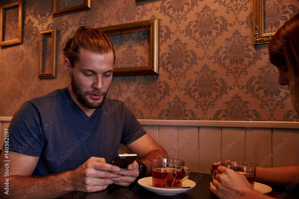 Young couple sitting in a pub Young couple sitting in a pub