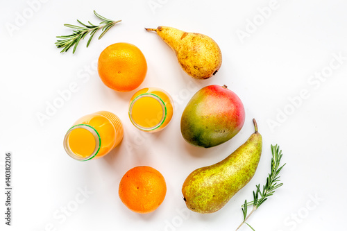 bottles of smoothie with fruits on white table top view