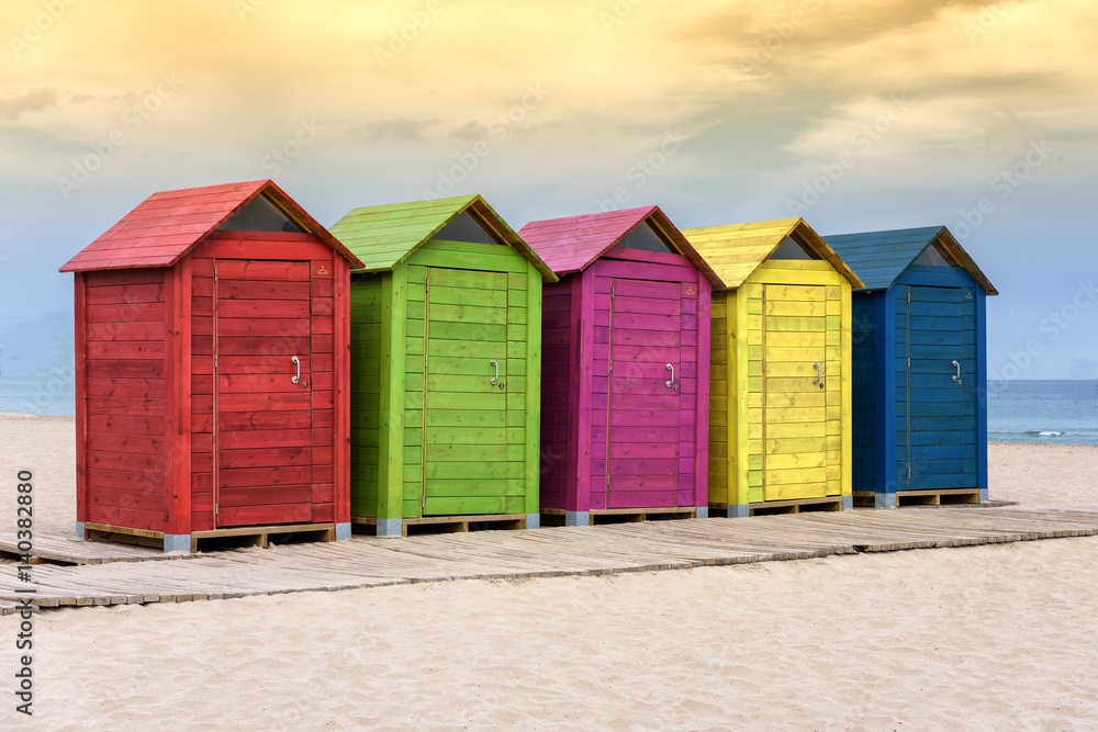 Colorful beach huts on sandy beach