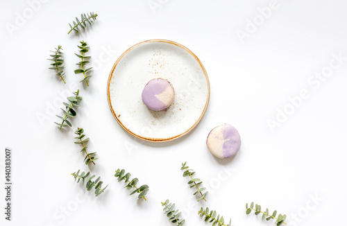 Spring design with macaroons and eucalyptus on white background top view mockup