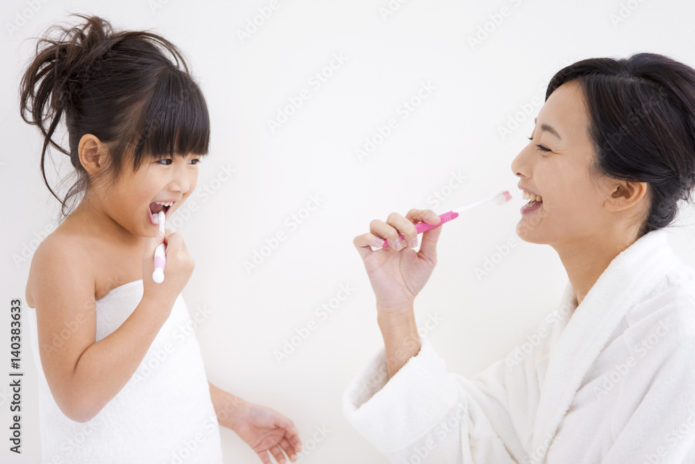 Mother and daughter brushing teeth Mother and daughter brushing teeth