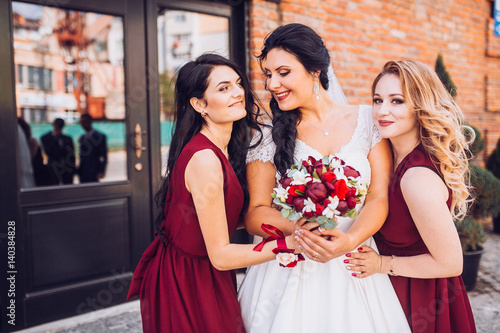 Laughing bride and bridesmaids tell funny stories 