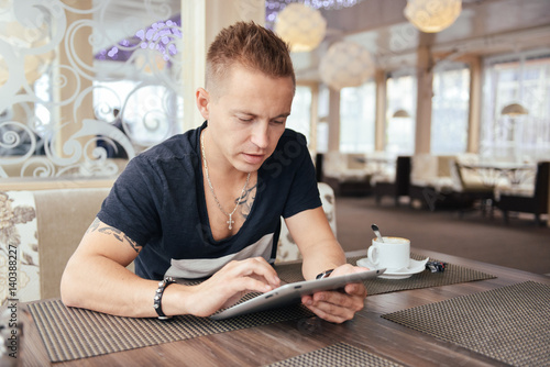 Portrait of a young man in a cafe photo