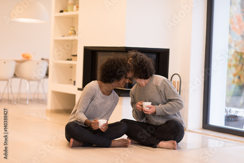 multiethnic couple in front of fireplace