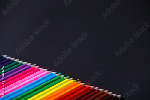 Obraz na płótnie Color wooden bright pencils shades range on a dark background