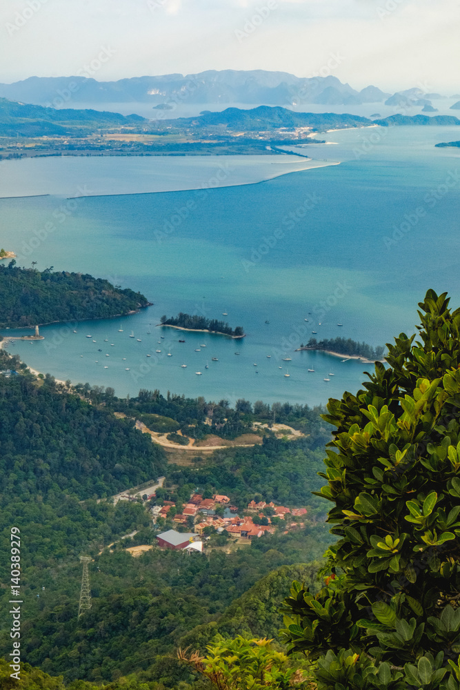 Panoramic view of residential village, blue sky, sea and mountain seen from Cable Car viewpoint, Langkawi Island, Malaysia.