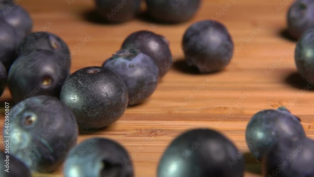 Large blueberries falls on the wooden table Large blueberries falls on the wooden table