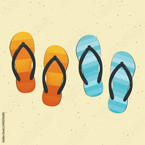 Pair of colorful flip-flops on sand