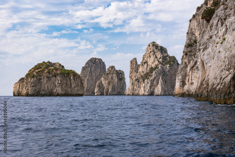 Cliff coast of Capri Island with famous Faragioni rocks