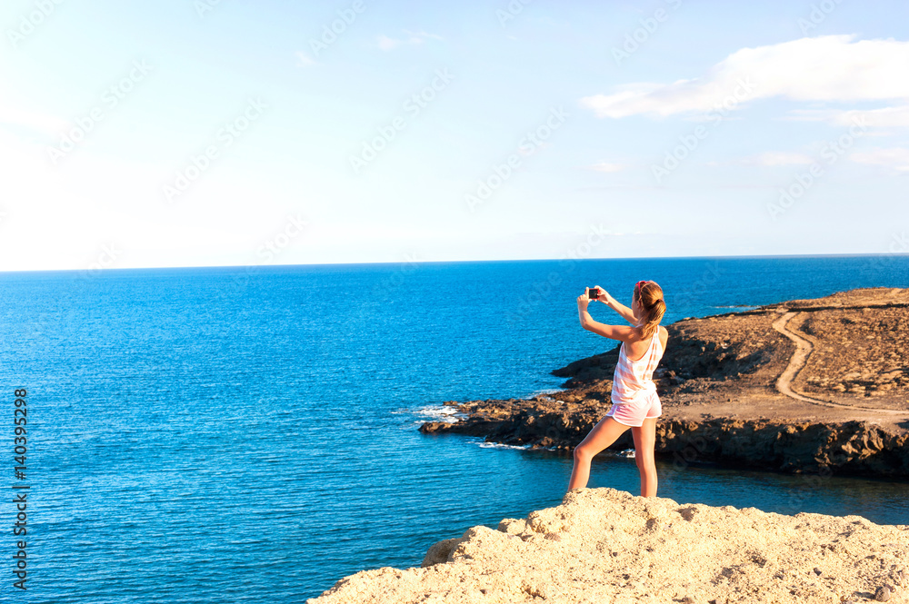 Travelling girl capturing the moment of beauty by smartphone. Travelling girl capturing the moment of beauty by smartphone.