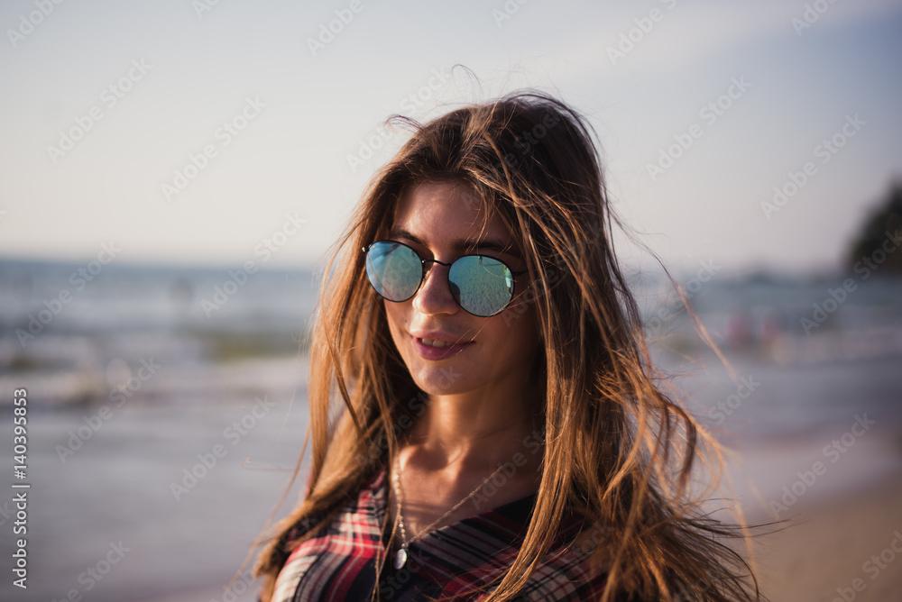 Close up beach portrait of cheerful blonde hipster. Wild girl on summer beach with sunglasses, hipster girl style, trendy Close up beach portrait of cheerful blonde hipster. Wild girl on summer beach with sunglasses, hipster girl style, trendy