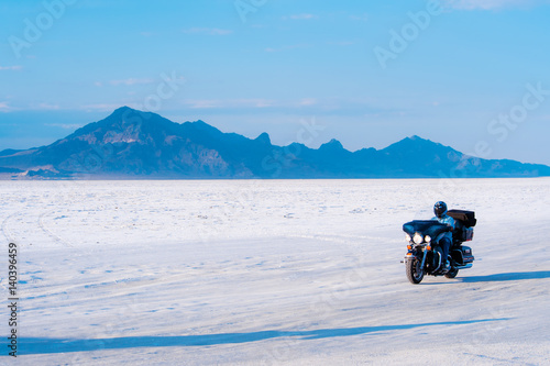 Biker driving across Bonneville Salt Flats in Utah, USA 