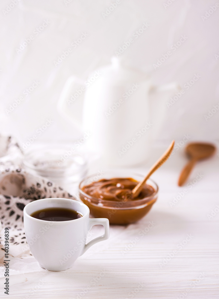 Bowl of homemade melted caramel sauce and coffee Bowl of homemade melted caramel sauce and coffee