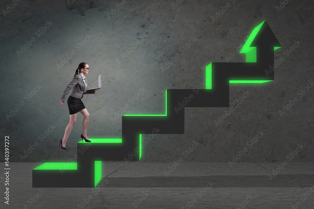 Young businesswoman climbing career ladder Young businesswoman climbing career ladder