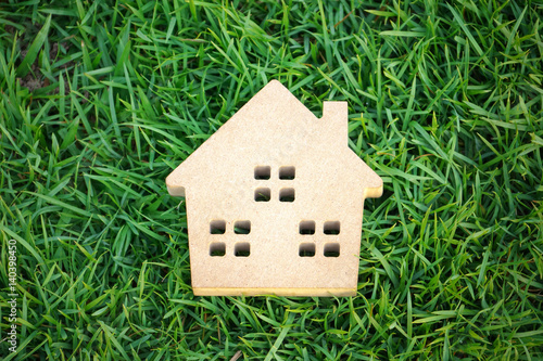 Wooden house on green grass / Eco house