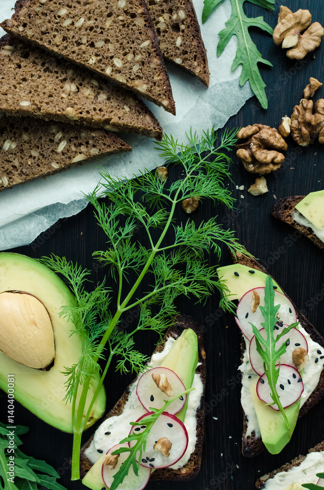Sandwiches of rye bread with avocado and goat cheese