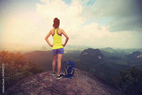 successful woman hiker enjoy the view hiking on mountain peak