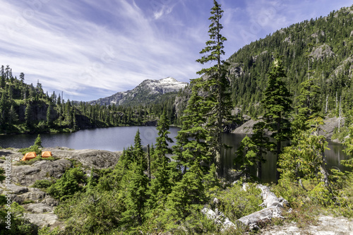 High alpine lake background with tents on a sunny day Strathcona Park Vancouver Island Canada