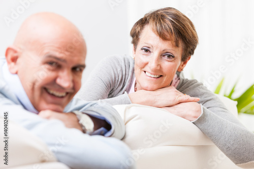 Relaxed friendly couple smiling at the camera
