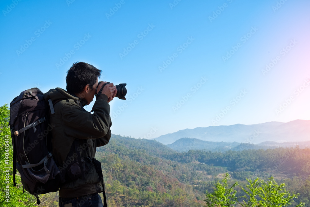 Man Traveler with photo camera and backpack hiking outdoor Travel Lifestyle and Adventure concept. Man Traveler with photo camera and backpack hiking outdoor Travel Lifestyle and Adventure concept.
