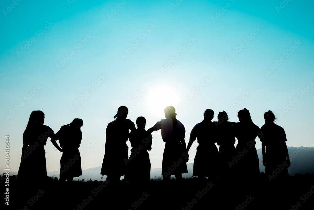 Group of happy people playing at summer sunset in nature Group of happy people playing at summer sunset in nature