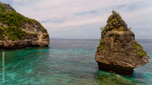 Aerial view of a cliff in the sea on the Suwehan beach. Nusa Penida, Indonesia.