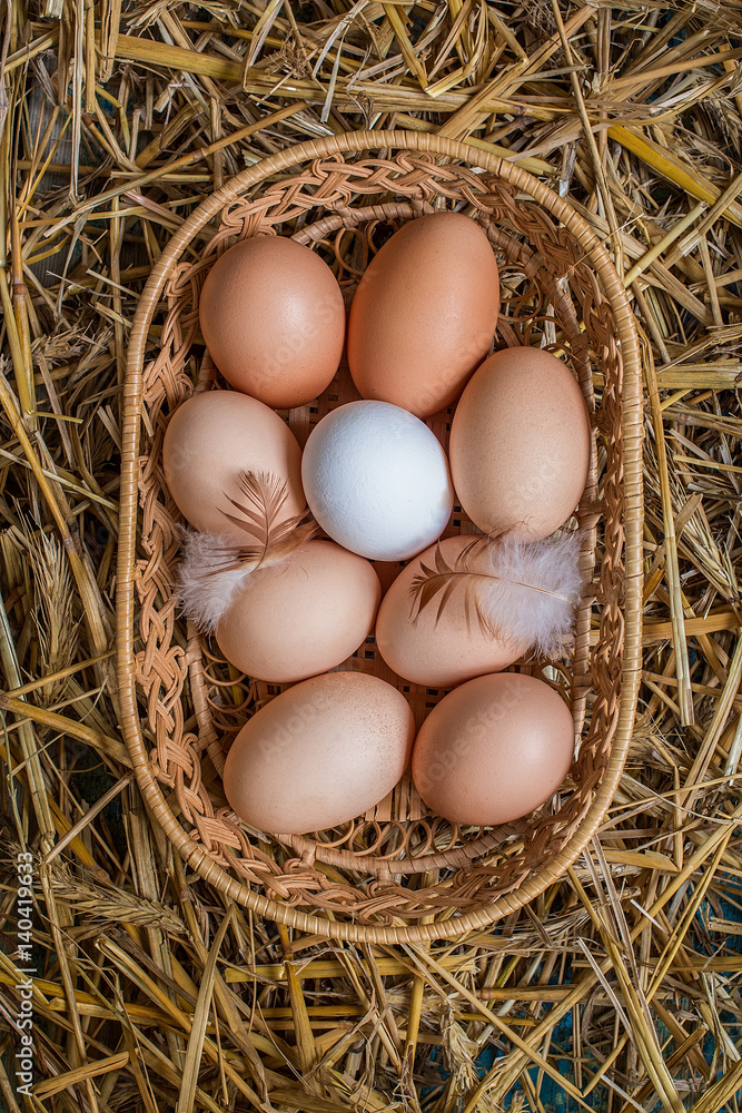 Eggs in wicker basket on table close-up