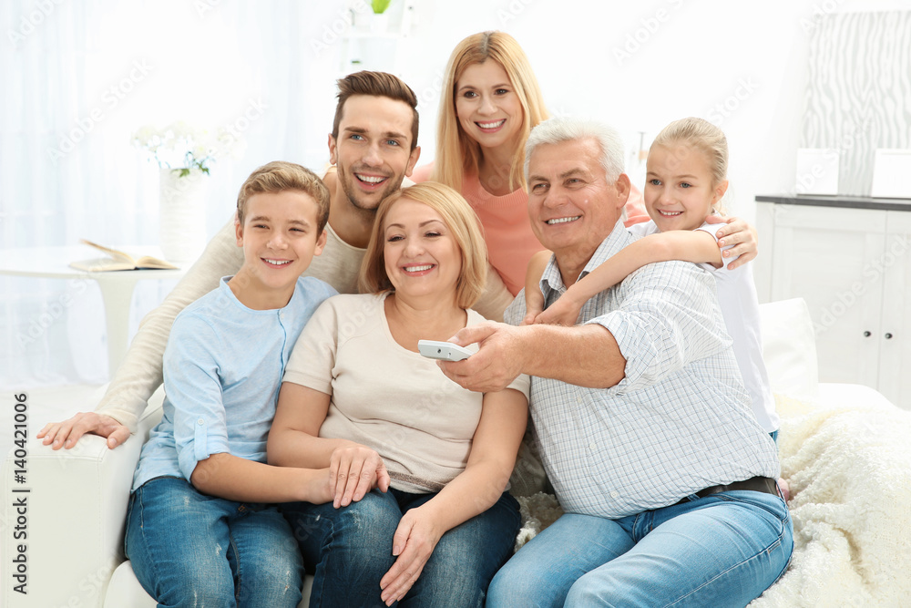 Happy family watching TV in living room