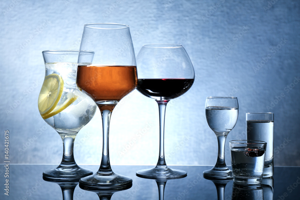 Different glasses of wine and spirits on color background Different glasses of wine and spirits on color background