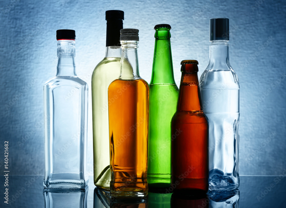 Different bottles of wine and spirits on color background Different bottles of wine and spirits on color background