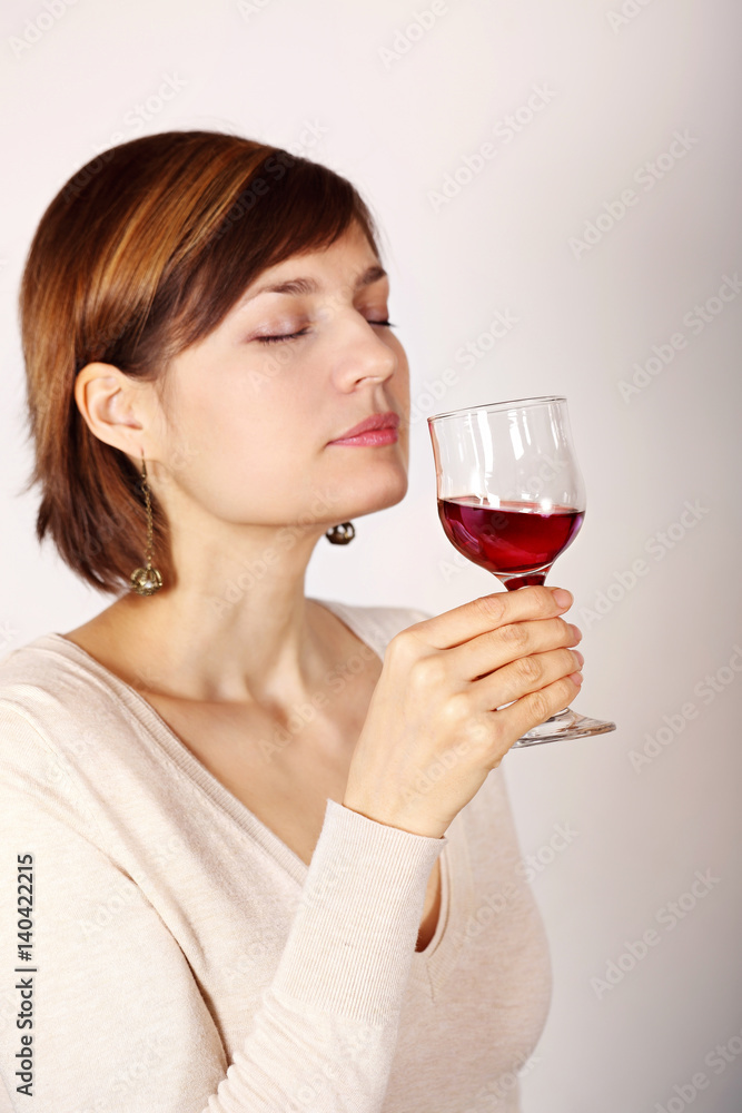 Young woman tasting pink wine Young woman tasting pink wine