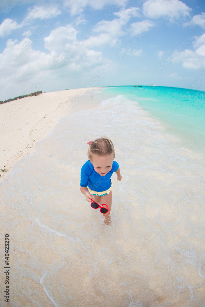 Little girl having fun in shallow water Little girl having fun in shallow water