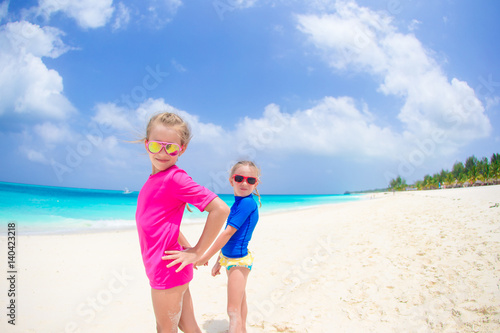 Girls having fun at tropical beach during summer vacation