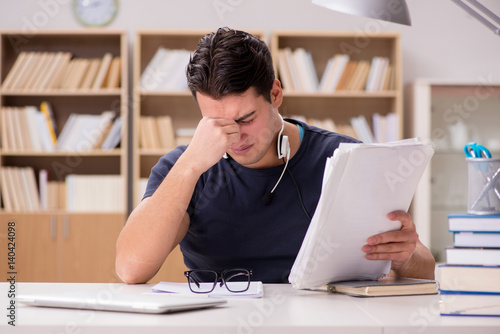 Unhappy student with too much to study