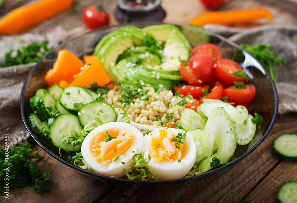 Diet menu. Healthy lifestyle. Bulgur porridge, egg and fresh vegetables - tomatoes, cucumber, celery and avocado on plate. Diet menu. Healthy lifestyle. Bulgur porridge, egg and fresh vegetables - tomatoes, cucumber, celery and avocado on plate.