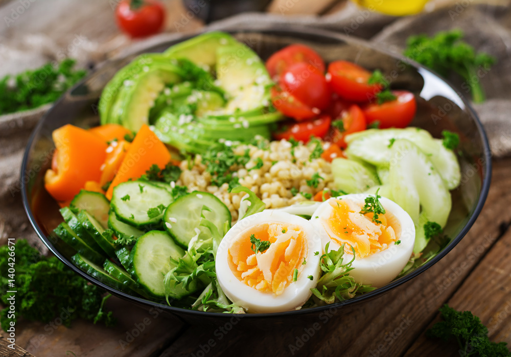 Diet menu. Healthy lifestyle. Bulgur porridge, egg and fresh vegetables - tomatoes, cucumber, celery and avocado on plate. Diet menu. Healthy lifestyle. Bulgur porridge, egg and fresh vegetables - tomatoes, cucumber, celery and avocado on plate.