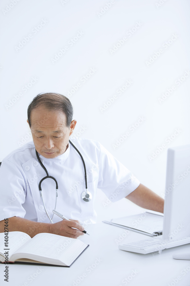 Male Doctor Working in Office Male Doctor Working in Office