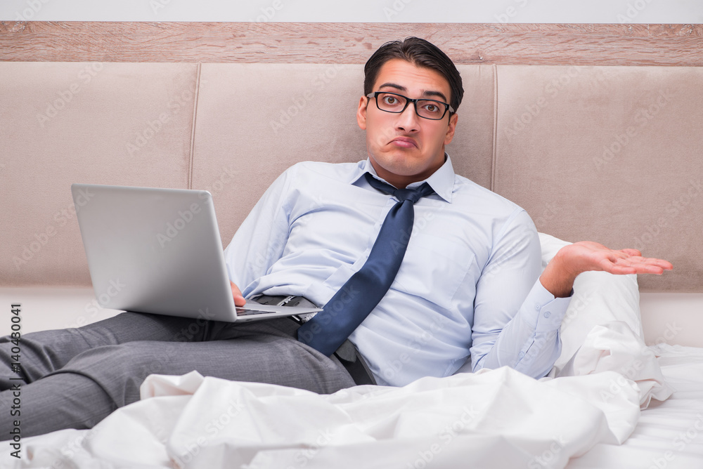 Businessman working in the bed at home Businessman working in the bed at home