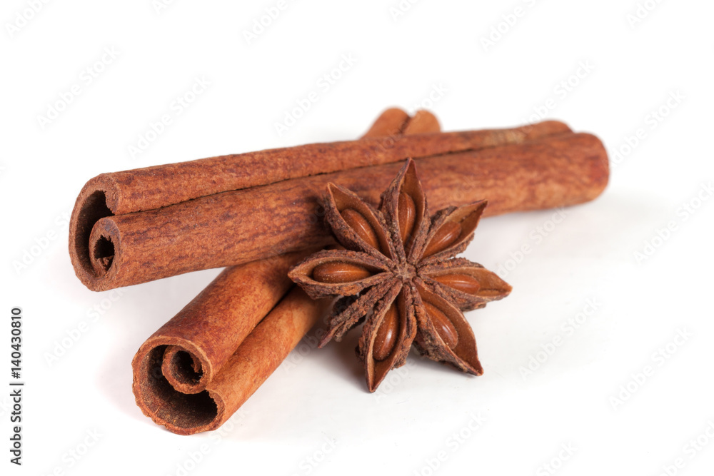 two cinnamon sticks with star anise isolated on white background two cinnamon sticks with star anise isolated on white background